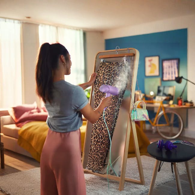 Philips 3000 Series Handheld Steamer STH3010/30 - Purple - 6 - woman drying pants, using hair dryer, leopard print pants