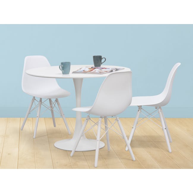 Carmen Round Dining Table 1m - White - 8 - Modern minimalist dining table with white chairs, light blue wall background