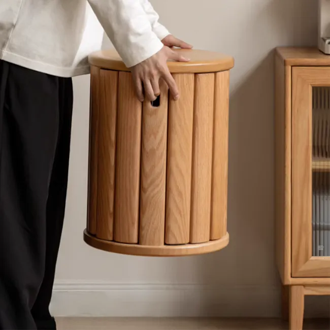 Coree Stackable Stool Set / Side Table - Oak - 14 - Wooden cylindrical trash can, person holding, light beige wall, wooden