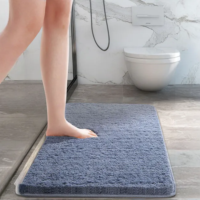 Shiloh Floor Mat - Iceberg - 4 - Bathroom, floor, rug, person standing, barefoot, white toilet, marble wall, modern design