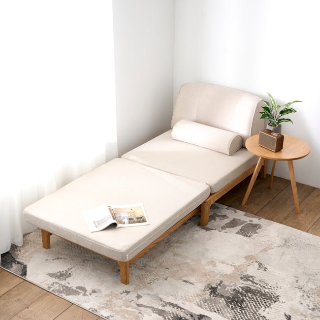 Zara Sofa Bed - Gravel White - 13 - Minimalist living room, cozy sofa, natural light, wooden coffee table, soft beige