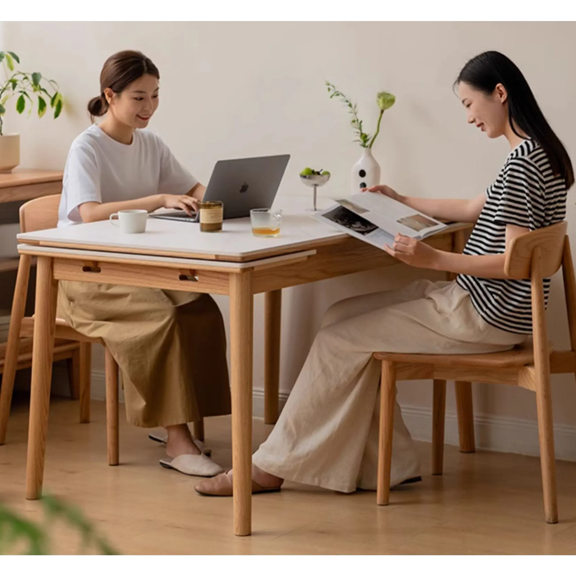 Fidela Extendable Dining Table 1.25-1.95m (Sintered Stone) - 15 - Two women working on laptops in a cozy home office