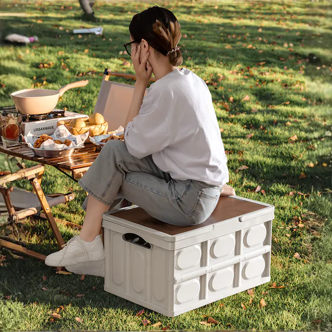 Blake Foldable Storage Box - Military Green - 4 - woman sitting outdoors, wearing glasses, white shirt, blue jeans, white