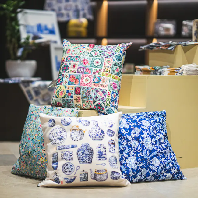 Singlapa Blue Porcelain Cushion Cover - 2 - Floral-patterned pillows with vibrant colors, including pink, green, blue, and