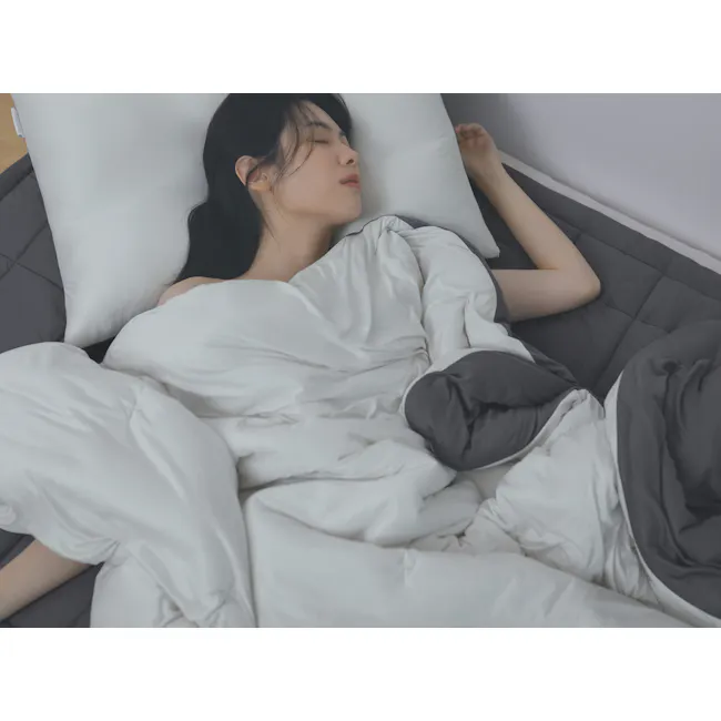 Bodyluv PO-ONG Blanket - Cream White & Charcoal (2 Sizes) - 3 - White comforter, gray pillows, person sleeping, black hair