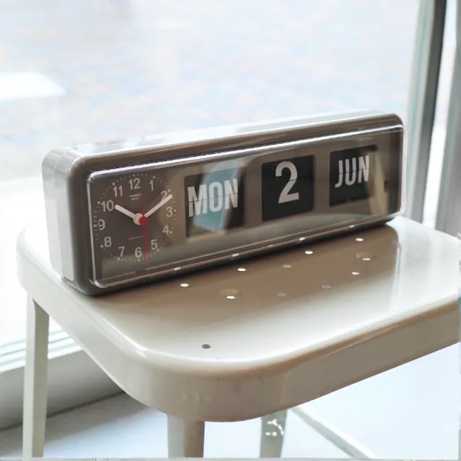 TWEMCO Calendar Flip Wall/Counter Clock - Grey - 4 - Monsoon alarm clock on a white table, Digital clock with clear display