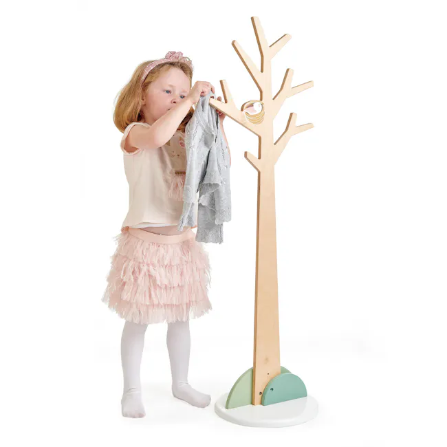Tender Leaf Forest Coat Stand - 2 - Little girl with light hair, wearing a pink headband, pink frilly skirt, white tights