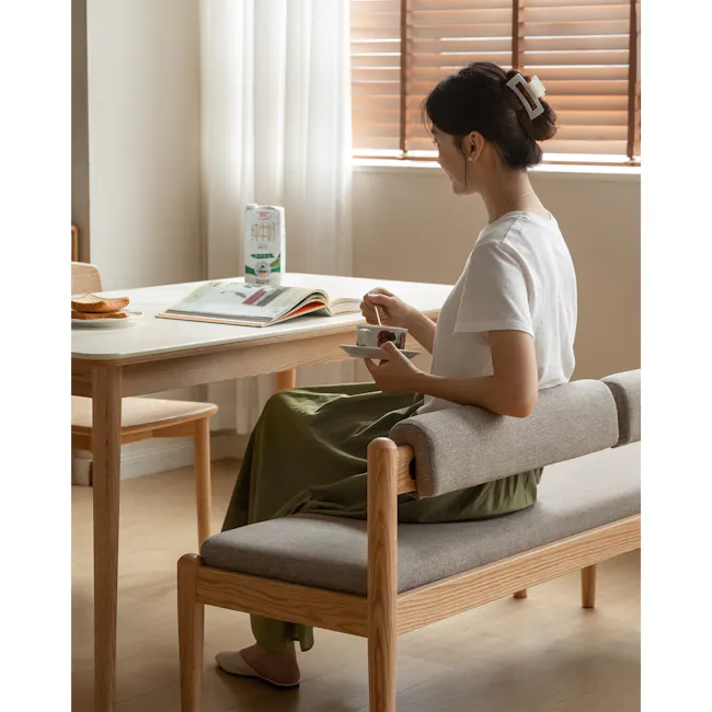 Niel Bench 1.05m - Oak, Chestnut - 9 - White room, cozy setting, woman sitting, light streaming through window, wooden
