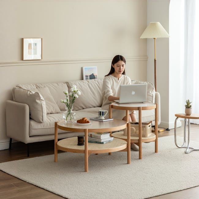 Lilian Rattan Coffee Table - Natural (Glass Tabletop) - 11 - Laptop, woman, sitting, working, on laptop, beige sofa, white