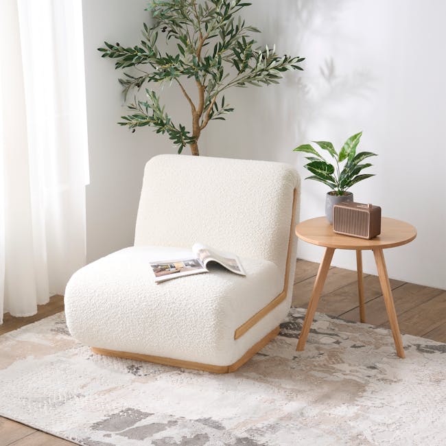 Eloise Lounge Chair - 3 - White textured armchair, cozy room, soft lighting, natural light, white curtains, wooden floor