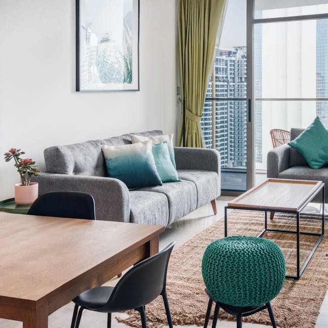 Bennett 3 Seater Sofa - Gray Owl - 3 - Modern living room with gray sofa, teal and white pillows, wooden coffee table, green