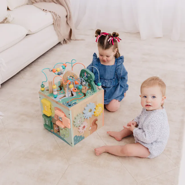 Bubble Wooden Activity Centre - 2 - Children's playroom, cozy living room, soft lighting, white curtains, beige carpet