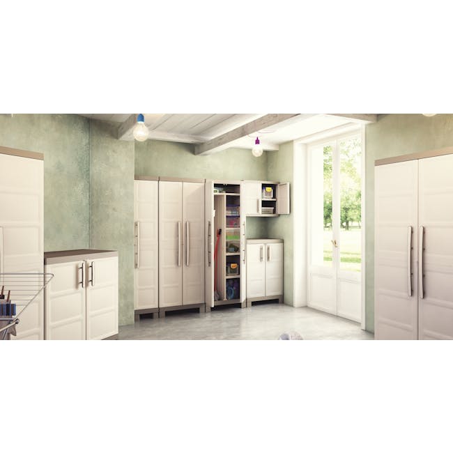 Excellence Utility Cabinet - 4 - White kitchen cabinets, open pantry, light green walls, concrete floor, natural light