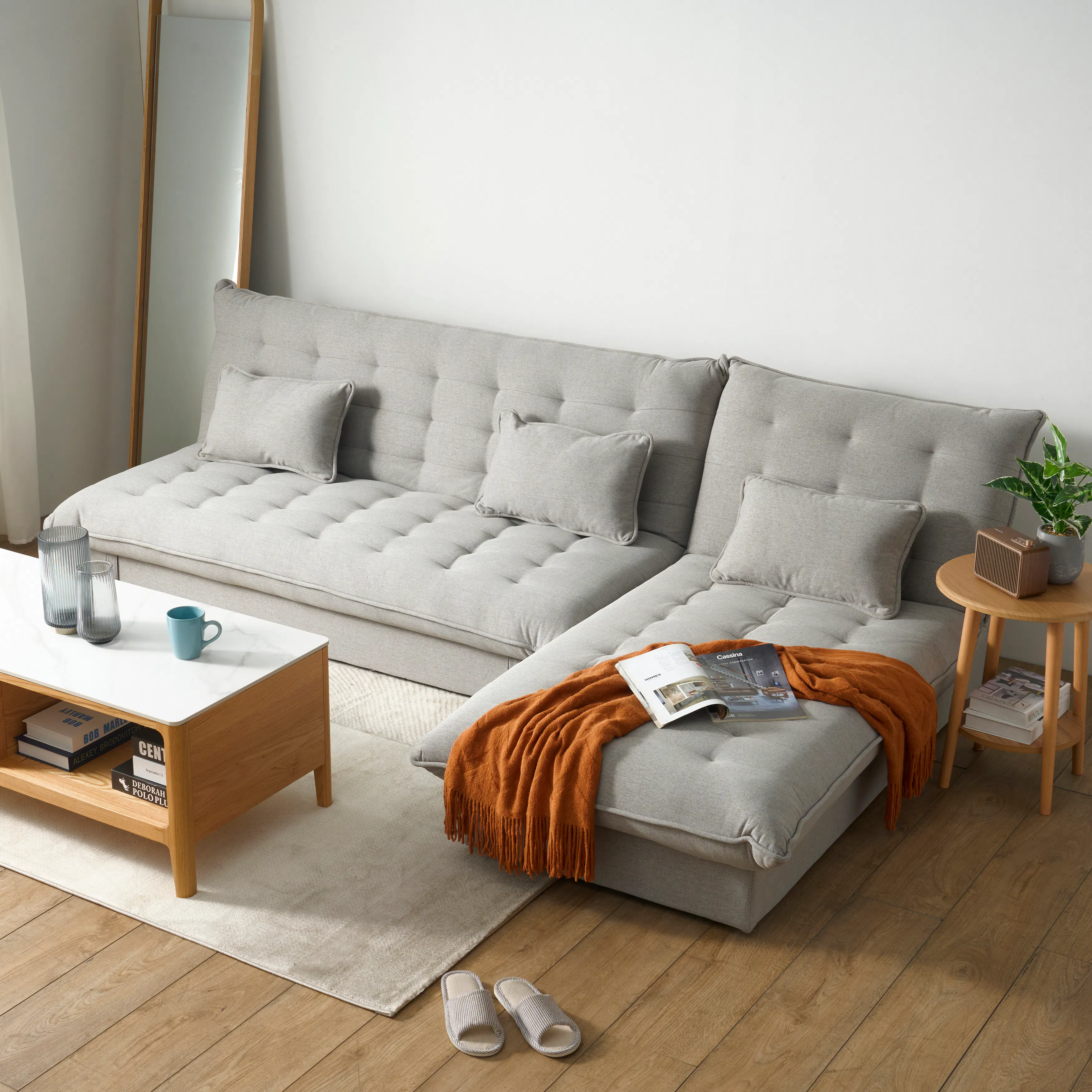 Tessa L-Shaped Sofa Bed - Beige (Eco Clean Fabric) - 41 - Light gray tufted sofa, wooden coffee table, orange throw blanket