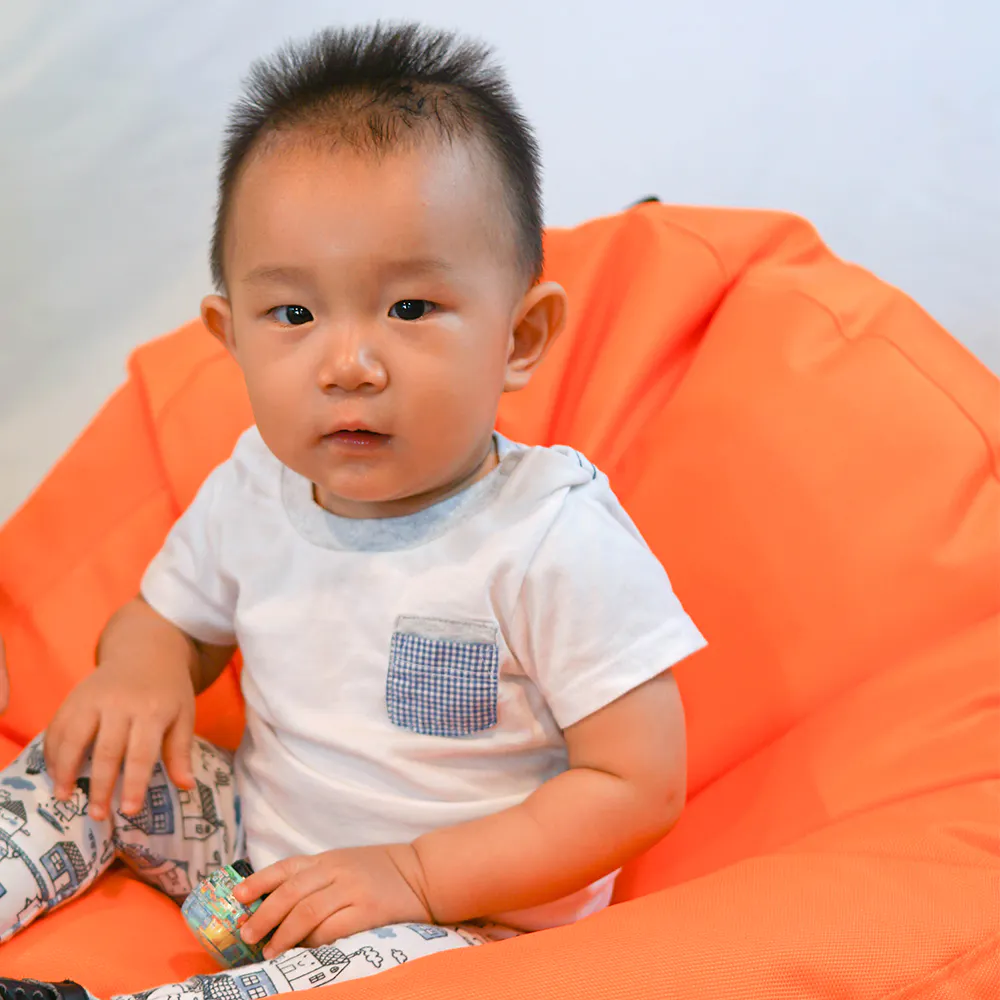 Doob Oomph Mini Bean Bag Chair - Candy Pink (Water Repellent) - 10 - Baby sitting on orange chair, white shirt with pocket