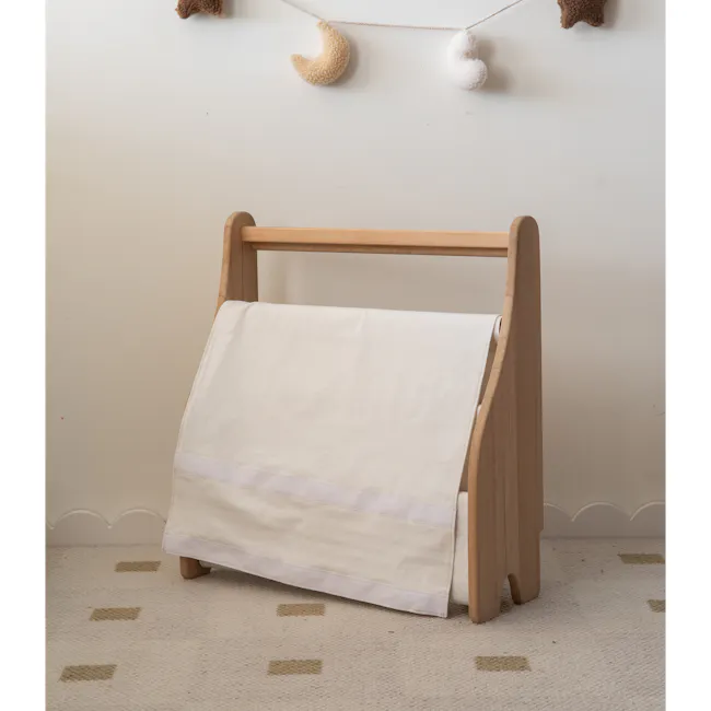 Micah Kids Storage Book Shelf Rack - 12 - Wooden crib with white blanket, soft beige wall, decorative hanging ornaments