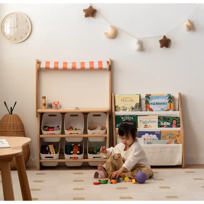Micah Kids Storage Book Shelf Rack - 17 - Wooden shelf with various toys, including a stuffed animal, books, and a wicker