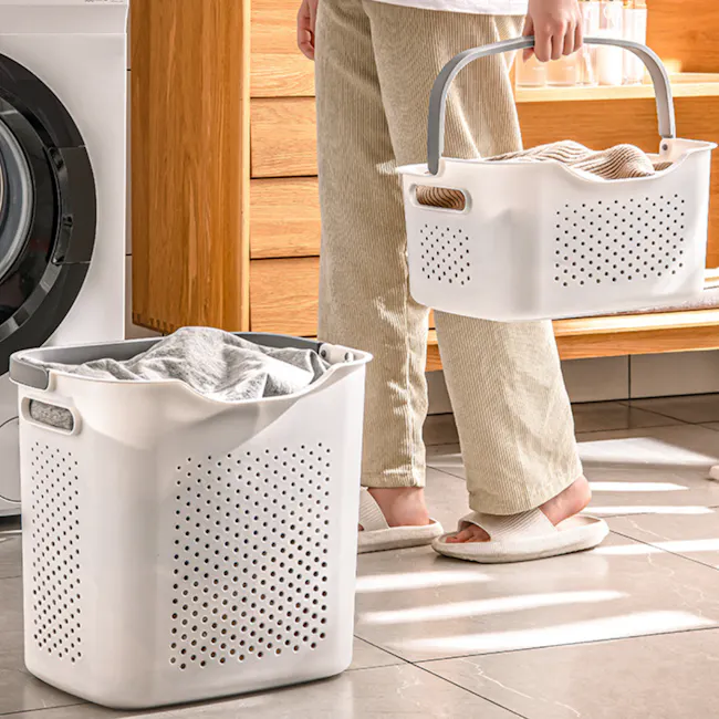 Elysian Laundry Basket - Shallow - 3 - white laundry basket, person holding laundry basket, white laundry basket on floor