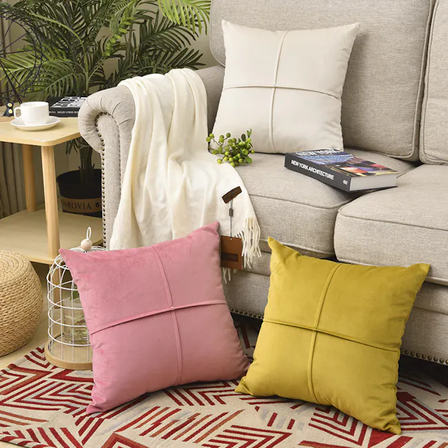 Ava Cushion - Grey - 4 - Cream sofa, white throw blanket, green plants, beige pillows, geometric rug, cozy living room