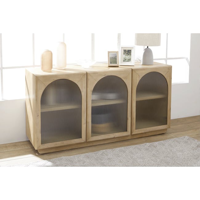 Catania Sideboard 1.6m - 4 - Light wood cabinet with glass doors, three glass-fronted shelves, beige lamp, white framed