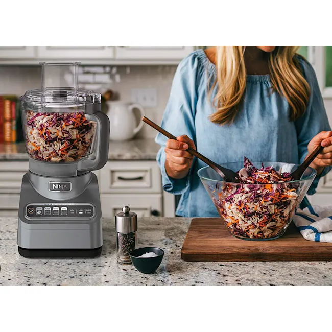 Ninja Professional Food Processor - 5 - Ninja food processor, kitchen countertop, woman preparing salad, clear blender jar