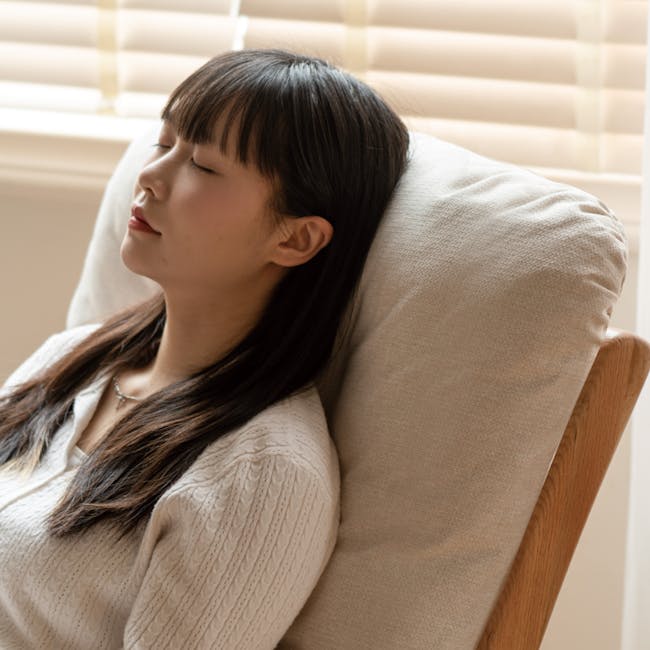 Kusa Rocking Lounge Chair with Ottoman - 11 - Smiling woman, peaceful expression, closed eyes, serene atmosphere, soft