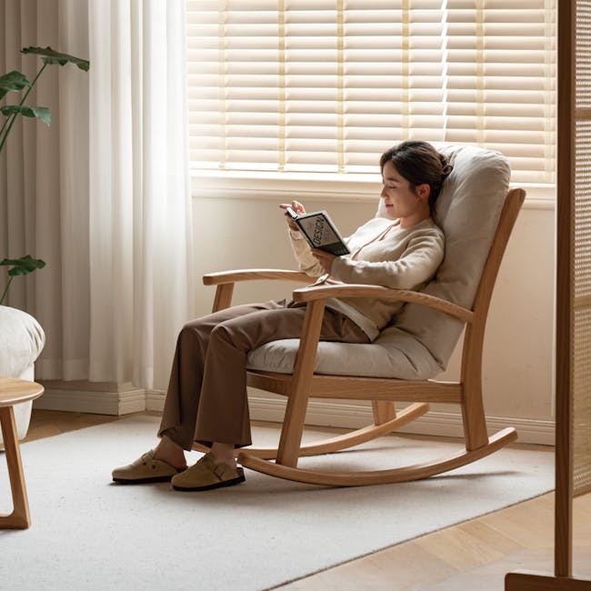 Kusa Rocking Lounge Chair with Ottoman - 13 - Light streaming through blinds, cozy wooden rocking chair, woman reading book