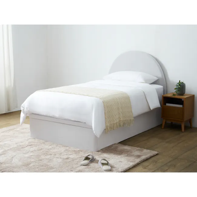 Aspen Super Single Storage Bed - Cloud White - 3 - White bed with beige blanket, wooden nightstand with green plant, beige