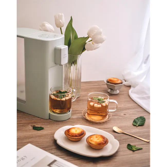 BRUNO Hot Water Dispenser - Green - 2 - smart tea maker, white tulips, cozy setting, tea cups, mint leaves, breakfast scene