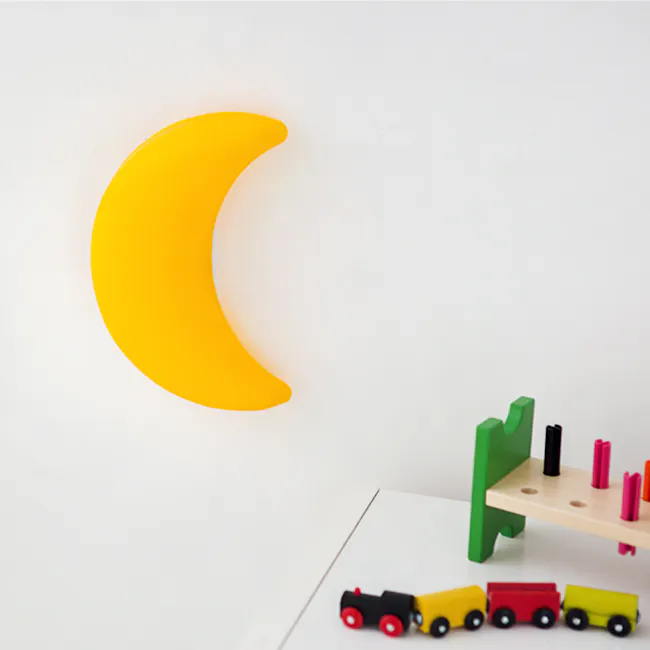 Kids Cresent Moon Wall Lamp - 4 - Yellow crescent moon, white background, toy cars, colorful trucks, wooden toy table, green
