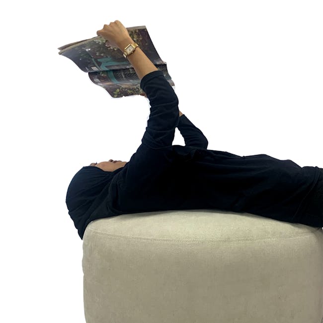 Pebble Ottoman - Thunder (2 Sizes) - 7 - laying, reading, magazine, hoodie, dark clothing, white background, relaxed, lying