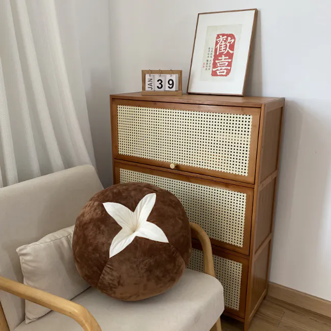 Mushroom Plush Cushion - 2 - Wooden side table with woven design, brown cushion with white flower pattern, beige chair