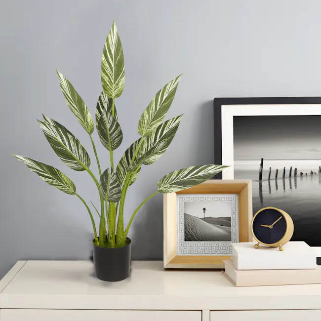 Potted Faux Alpinia Plant 80 cm - 2 - Green leafy plant, indoor setting, modern decor, white desk, framed picture, abstract