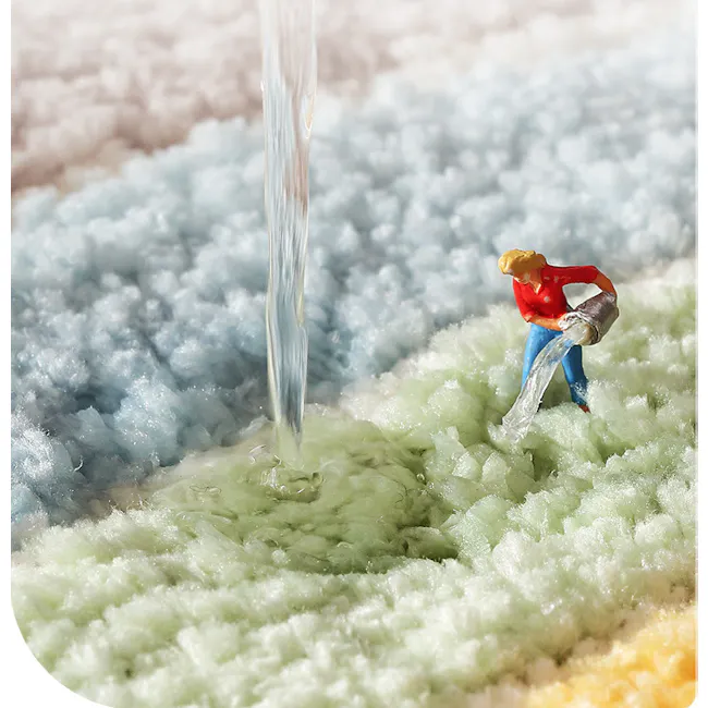 Toby Bath Mat - Bathtub - 3 - Water pouring from a small figure, blue and green foam surface, toy figure holding a bucket