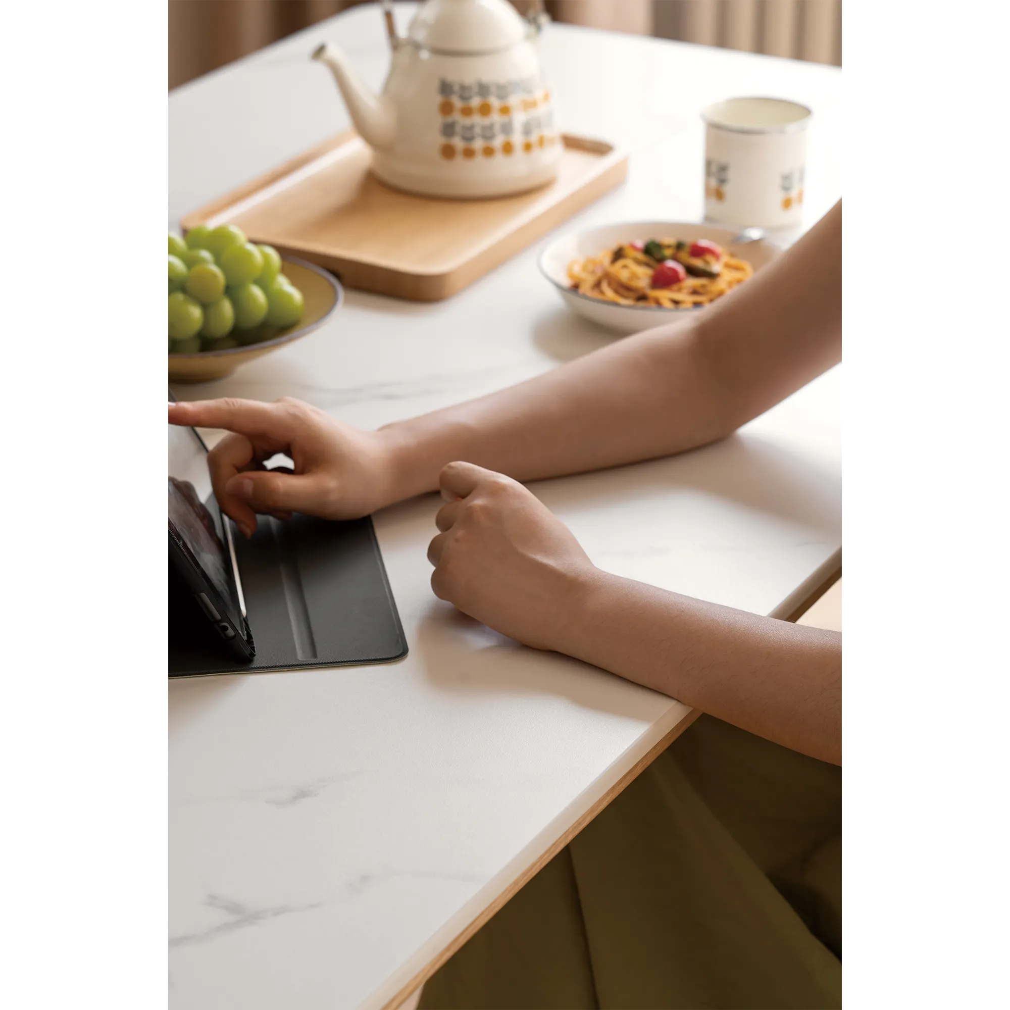 Nellie Dining Table 1.4m - Oak (Sintered Stone) - 27 - Tea set, tablet, person's hands, meal, green grapes, wooden tray