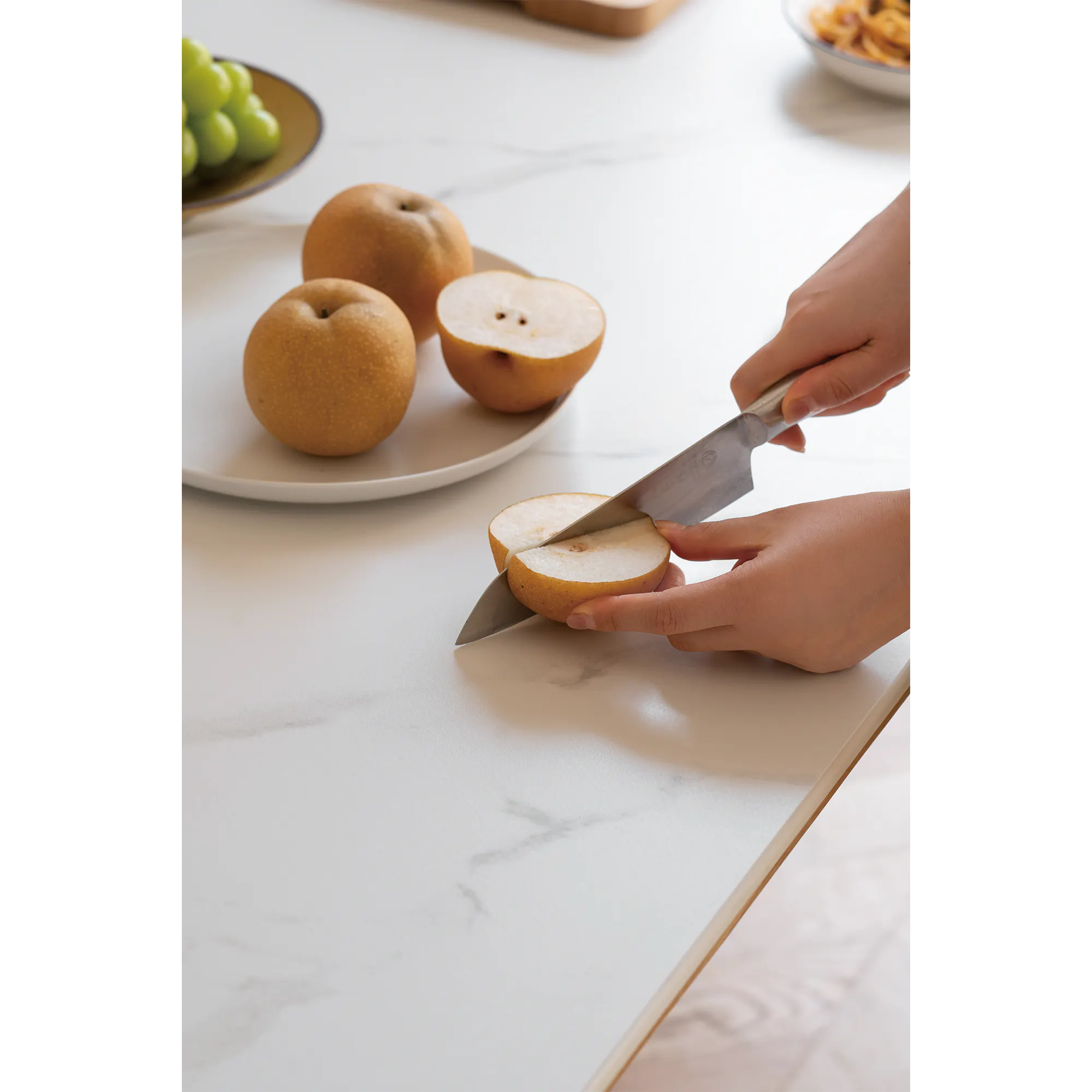 Nellie Dining Table 1.4m - Oak (Sintered Stone) - 16 - Fresh fruit preparation, hand slicing fruit, kitchen countertop