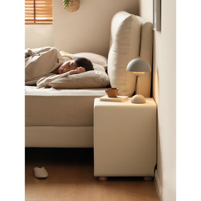 Nolan King Storage Bed in Silver Fox with 2 Asher Narrow Bedside Table - 21 - Soft, cozy bedroom scene, person sleeping on
