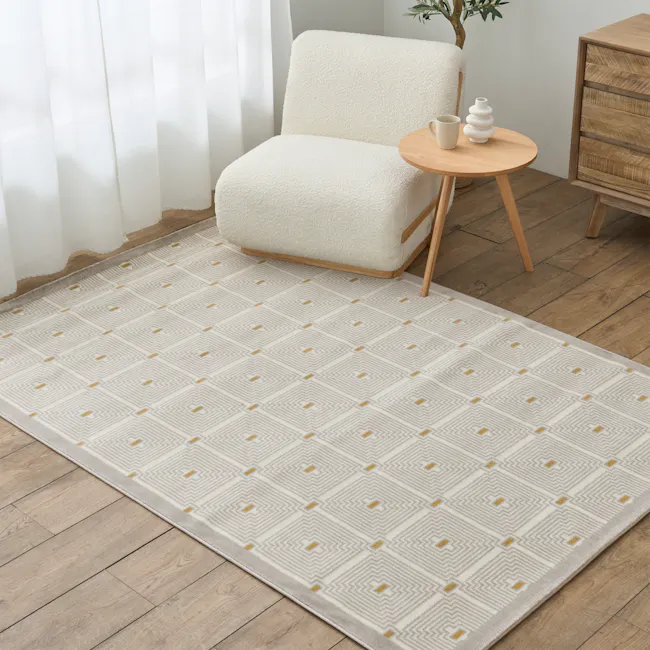 Luca Low Pile Rug - Geosquare (3 Sizes) - 2 - White textured armchair, wooden floor, geometric patterned rug, light beige