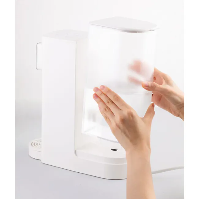 BRUNO Hot Water Dispenser - Green - 7 - White coffee machine, transparent filter, person holding filter, modern kitchen