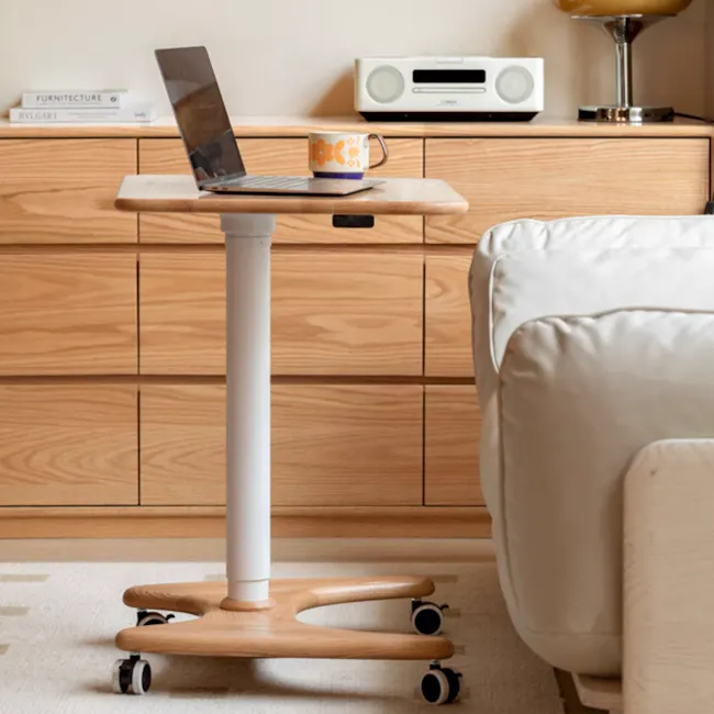 Easton Adjustable Table 0.6m - Oak, White - 5 - Wooden rolling desk, laptop on top, white mug, modern workspace, minimalist