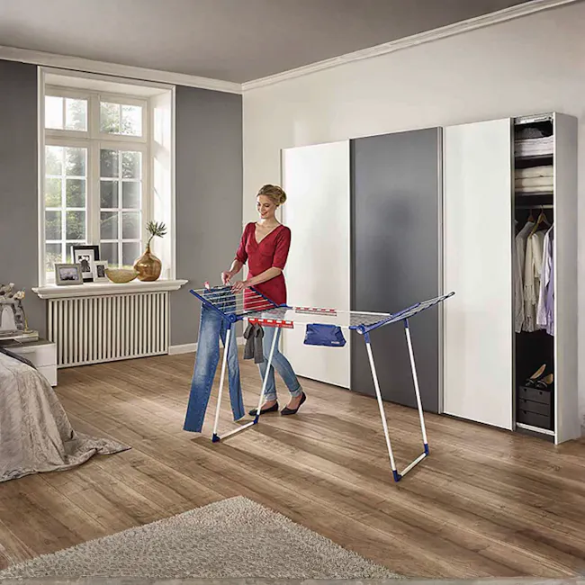 Leifheit Pegasus Maxx Clothes Dryer - 2 - Red dress, woman, folding table, wooden floor, wardrobe, clothes, closet, natural