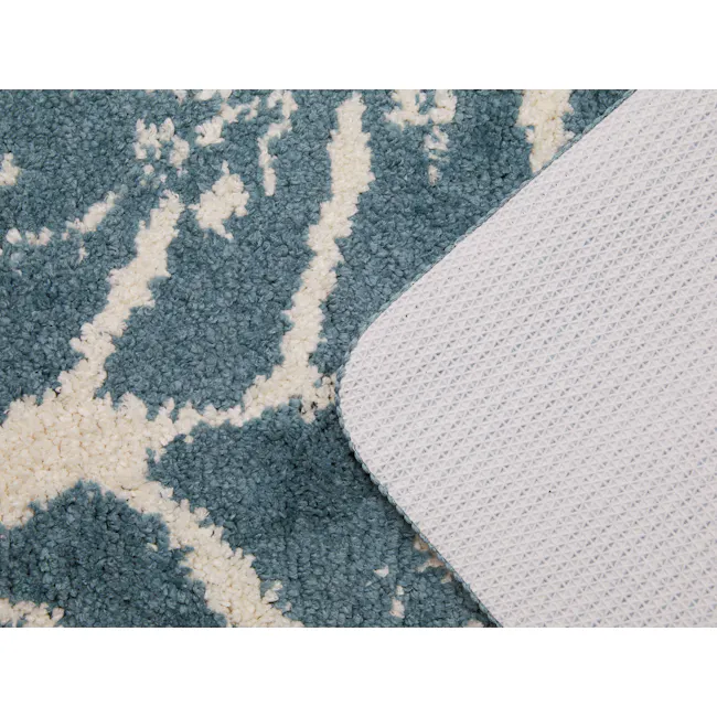 Tropical Floor Mat - Monstera - 2 - Turquoise and white textured carpet, blue and white patterned fabric, intricate diamond