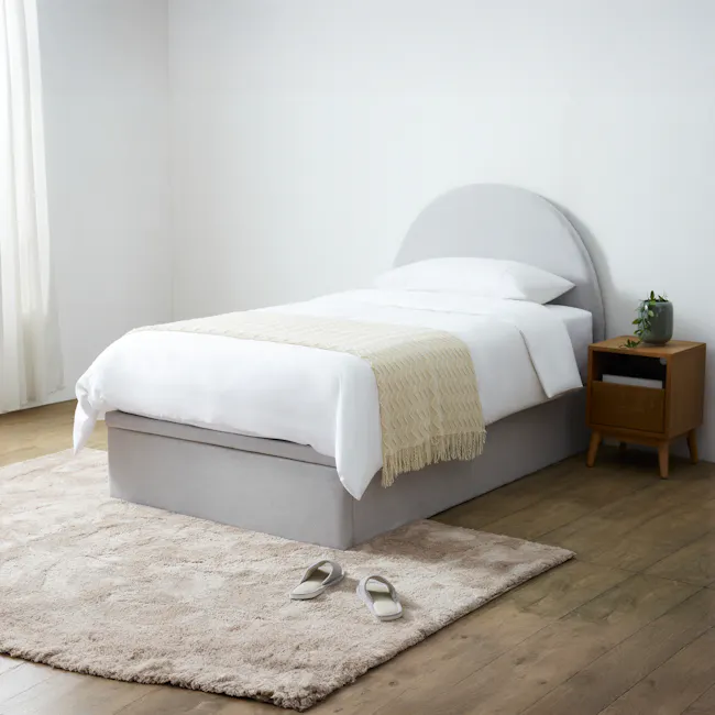 Aspen Super Single Storage Bed - Ice Grey - 2 - White bed with beige blanket, wooden nightstand with green plant, light