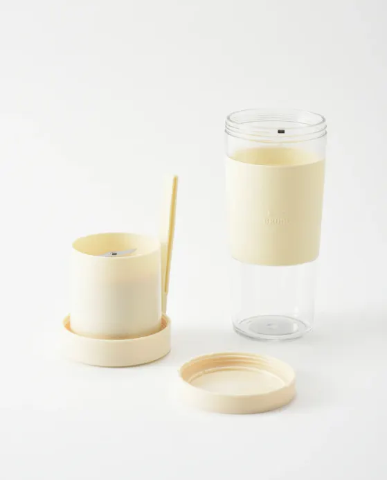 BRUNO Cordless Blender - Pink - 11 - Clear candle holder, minimalist design, soft yellow color, cylindrical shape, open lid