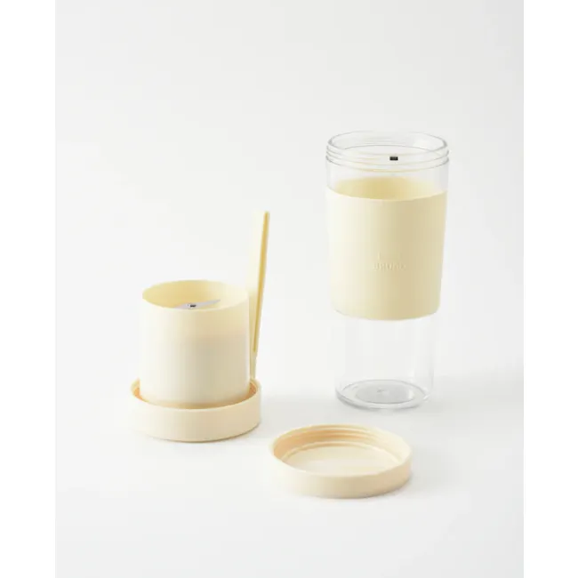 BRUNO Cordless Blender - Pink - 11 - Clear candle holder, minimalist design, soft yellow color, cylindrical shape, open lid