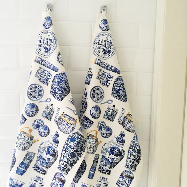 Singlapa Blue Porcelain Tea Towel - 2 - Blue and white patterned towels, hanging on hooks, bathroom wall tiles, traditional