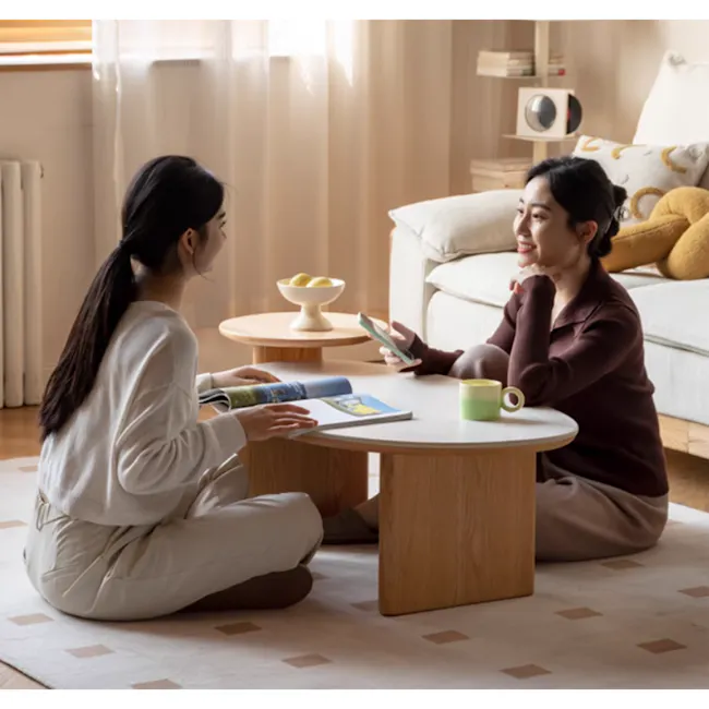 Colette Coffee Table (Sintered Stone) - 2 - Cozy living room with soft, natural lighting, Two women sitting on a rug