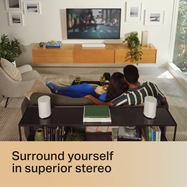 Sonos Era 100 - Black - 8 - Sleek modern living room with comfortable seating and contemporary decor., Indoor setting with a
