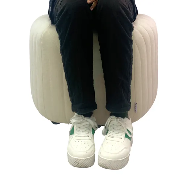 Caceda Ottoman - Dark Grey (2 Sizes) - 11 - White, cushioned, upright, person sitting, black pants, white sneakers with