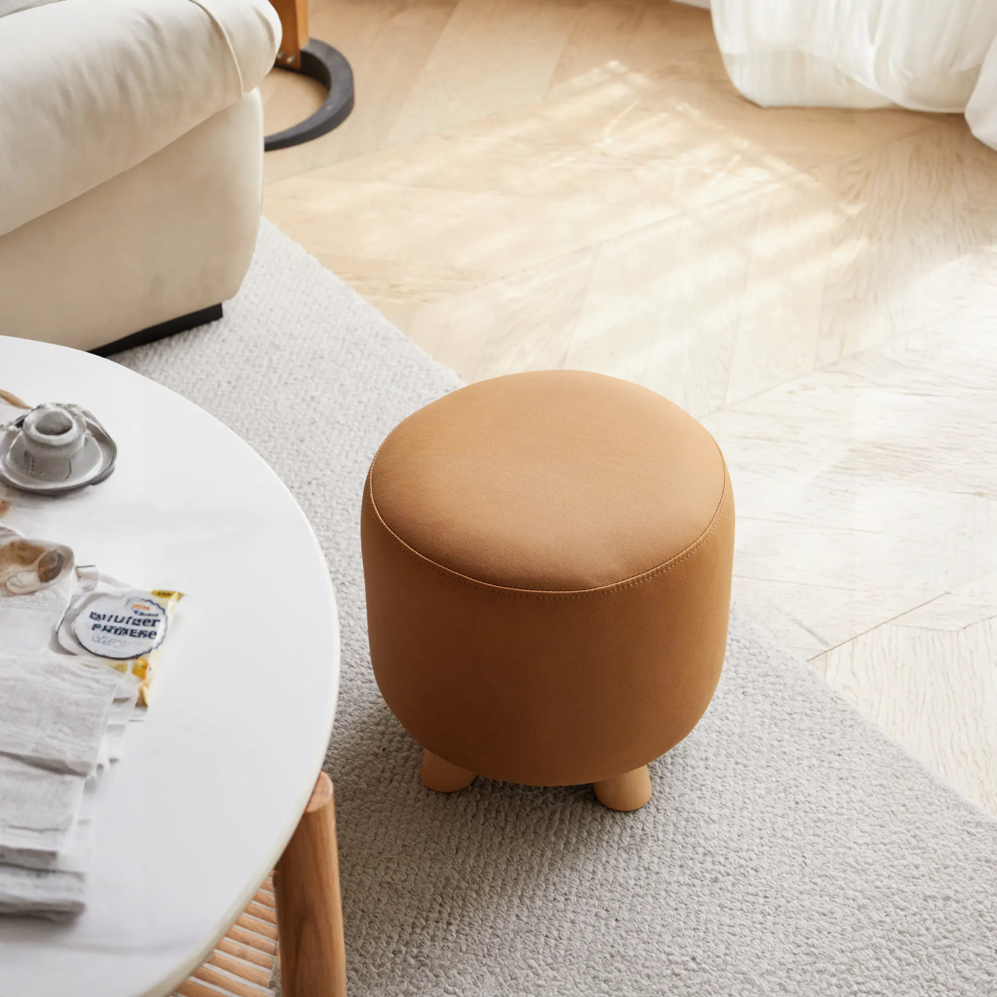 Niyo Stool - Tan - 9 - Cream-colored ottoman, beige sofa, wooden floor, light hardwood floor, round white coffee table